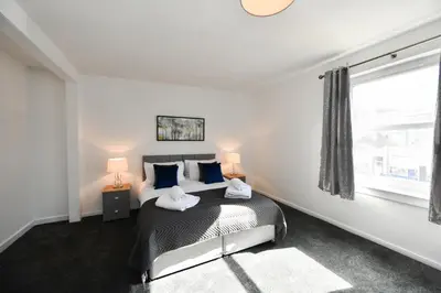 a bedroom with a bed with two pillows on it at Mews House in Ayr