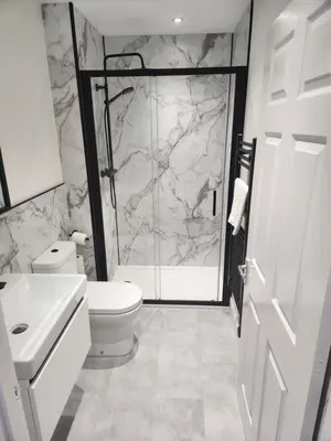 a bathroom with a shower and a toilet and a sink at No 8 Westbay Apartment in Oban