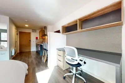 a bedroom with a desk and a chair in a room at Canvas Glasgow in Glasgow
