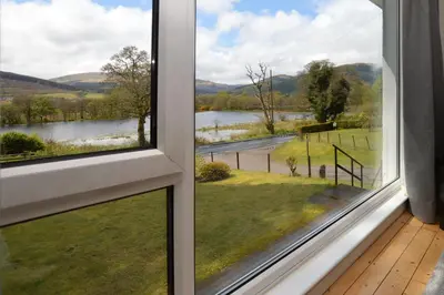 a window view of a lake from a house at Nursery Cottage in Kilmun
