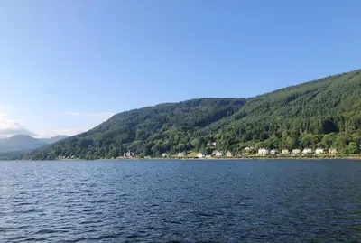 a view of a lake with mountains in the background at Nursery Cottage in Kilmun