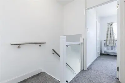 a room with white walls and a glass door at Dreghorn House 5 b-rooms 9 beds 3 toilets 2 showers,1 bath 2 receiption Secure free Parking 233 Wifi in Edinburgh