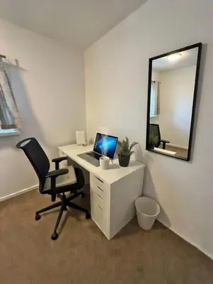 an office with a desk with a laptop and a chair at Dreghorn House 5 b-rooms 9 beds 3 toilets 2 showers,1 bath 2 receiption Secure free Parking 233 Wifi in Edinburgh