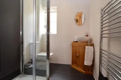 a bathroom with a sink and a shower at High Beach Cottage in Kames