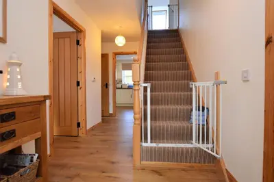 a staircase in a home with a stair case at High Beach Cottage in Kames