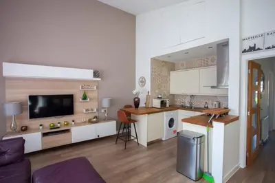 a kitchen with white cabinets and a counter top at Mosspark Boulevard Exec Apartment ii - Free Parking in Glasgow