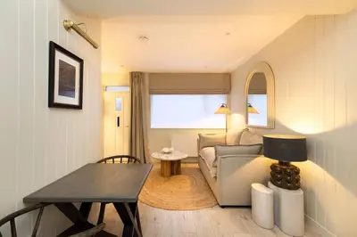 a living room with a couch and a table at Argyl - Central Old Town Mews Home with Parking in Edinburgh