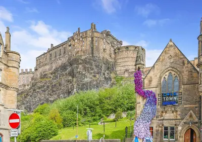 a building with a statue of a woman on the side of it at Argyl - Central Old Town Mews Home with Parking in Edinburgh
