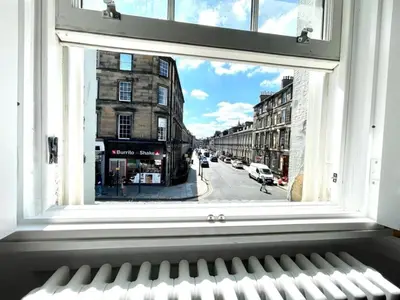 a window with a view of a city street at Modern & Spacious 1 Bed Apt, West End in Edinburgh