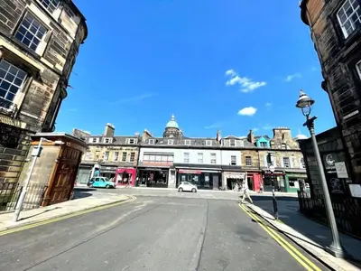 an empty street in front of a large building at Modern & Spacious 1 Bed Apt, West End in Edinburgh
