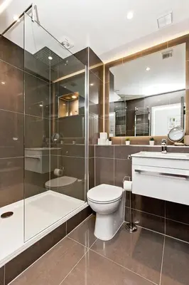 a bathroom with a toilet and a shower and a sink at Modern & Spacious 1 Bed Apt, West End in Edinburgh