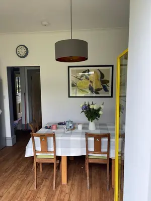 a dining room with a white table and chairs at Arran School House - Blackwaterfoot, Isle of Arran in Blackwaterfoot