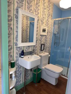 a bathroom with a sink and a toilet and a mirror at Arran School House - Blackwaterfoot, Isle of Arran in Blackwaterfoot