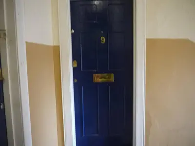 a blue door with a gold knocker on it at Fabulous location, One Bedroom West End Flat, just off Byres rd, close to SEC & Hydro in Glasgow