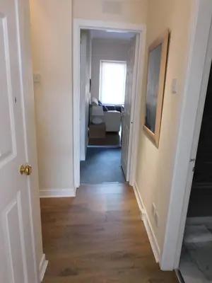 a hallway leading into a living room with a hallway at Fabulous location, One Bedroom West End Flat, just off Byres rd, close to SEC & Hydro in Glasgow