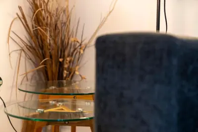 a table with two glass tables with a plant at Saughton Suite with views of Water of Leith in Edinburgh