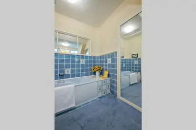 a blue tiled bathroom with a tub and a sink at Troon Arts & Crafts Period Home Golf Beach in Troon