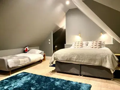 a bedroom with two beds and a blue rug at The Lodge at Muir Estate in Thornhill