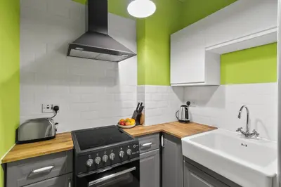 a kitchen with a stove and a sink at Bay Apartment in Helensburgh