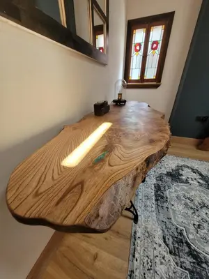 a table made out of a log in a room at Loch Lomond Blair Byre in Rowardennan