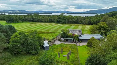 an aerial view of a house in a field at Loch Lomond Blair Byre in Rowardennan