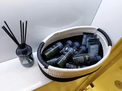 a basket filled with batteries on a counter next to a vase at Quartermile Luxury Landing Apartment in Edinburgh