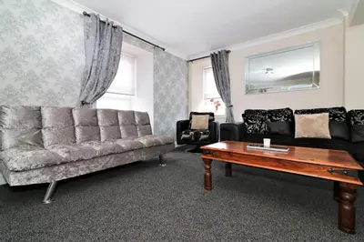 a living room with a couch and a coffee table at Signature - Kirkhill Lower in Kirkmuirhill