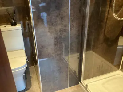 a bathroom with a shower and a toilet at Auchenlea bed and breakfast in Coatbridge
