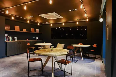 a restaurant with two tables and chairs and lights at For Students Only Modern studios in Glasgow West End in Glasgow