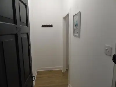 a hallway with an open door to a room at Snug - Sealladh Mara Apartment in Helensburgh