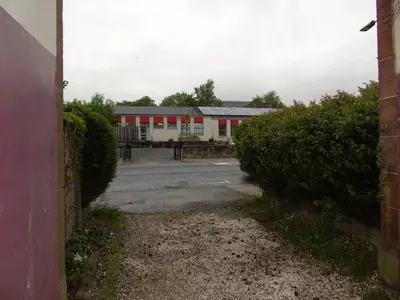 an empty parking lot in front of a building at Snug - Sealladh Mara Apartment in Helensburgh