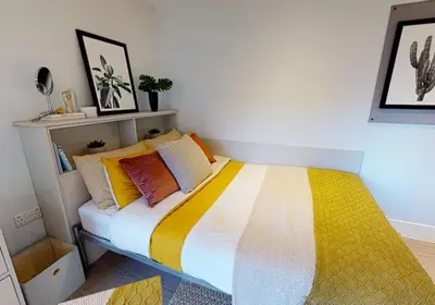 a bedroom with a bed with colorful pillows at iQ Grove Accomodation in Edinburgh in Edinburgh