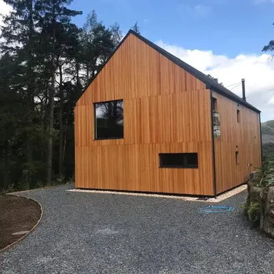 An Caisteal Lodge with cascading waterfall view