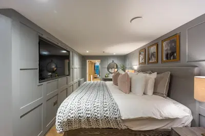a bedroom with a large bed and a television at No1 Apartments Edinburgh - New Town in Edinburgh