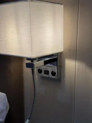 a lamp on a wall with a light on it at Ultra Modern, Stylish Apartment Next To Princes St in Edinburgh