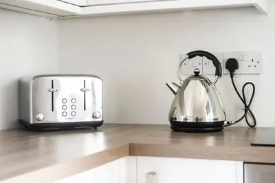 a tea kettle on a counter next to a toaster at Lothian Road - perfect city centre location. in Edinburgh
