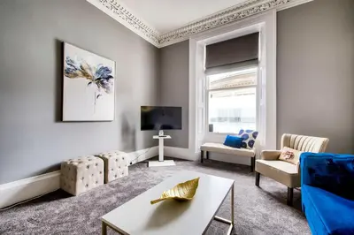a living room with a couch and a tv at Lothian Road - perfect city centre location. in Edinburgh