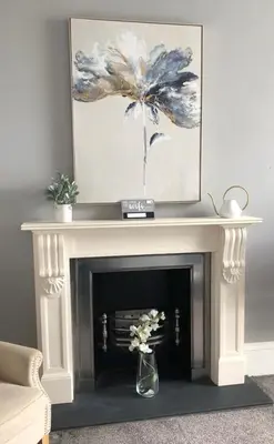 a living room with a fireplace with a painting at Lothian Road - perfect city centre location. in Edinburgh