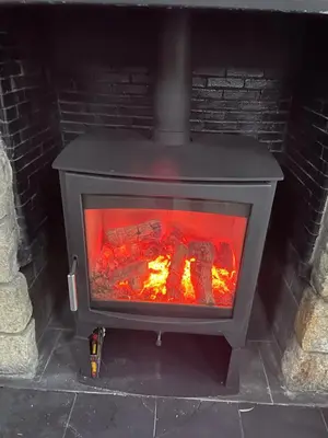a stove with a fire in a brick oven at Dalgarven spa venue in Kilwinning