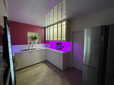 a pink kitchen with a sink and a window at Dalgarven spa venue in Kilwinning