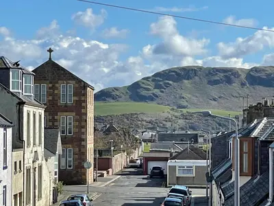 a street in a town with mountains in the background at Number 53 in Girvan