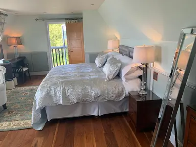 a bedroom with a bed and a table with two lamps at Corrie House in Craobh Haven