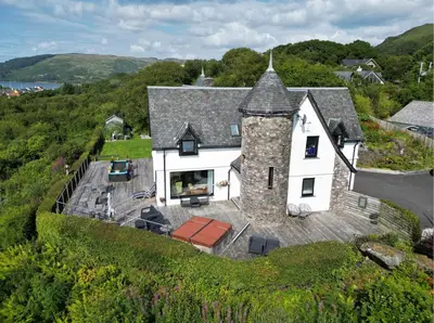 an aerial view of a white house with a roof at Corrie House in Craobh Haven