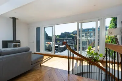 a living room with a couch and a fireplace at The Edinburgh Rooftop Terrace in Edinburgh