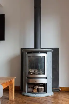 a fireplace in a living room next to a table at The Edinburgh Rooftop Terrace in Edinburgh