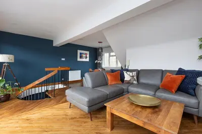 a living room with a couch and a table at The Edinburgh Rooftop Terrace in Edinburgh