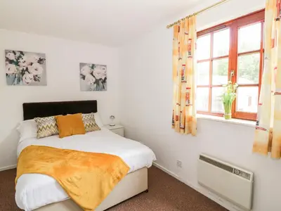 a bedroom with a bed and a window at Brunston Castle in Girvan