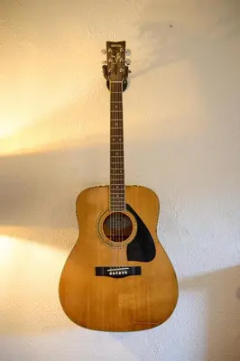 a wooden guitar hanging on a wall at Charming Apt nr Centre - Terrace & Street Parking in Oban