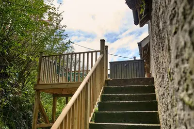 a stairway leading up to a house with a deck at Charming Apt nr Centre - Terrace & Street Parking in Oban