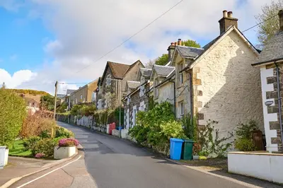 an empty street in a town with houses at Charming Apt nr Centre - Terrace & Street Parking in Oban